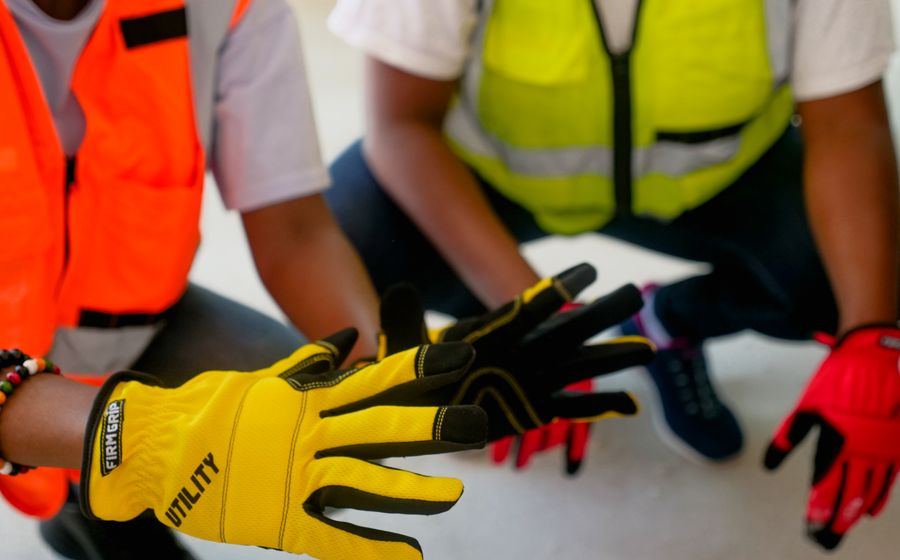 Workers wearing protective gloves and high visibility vests